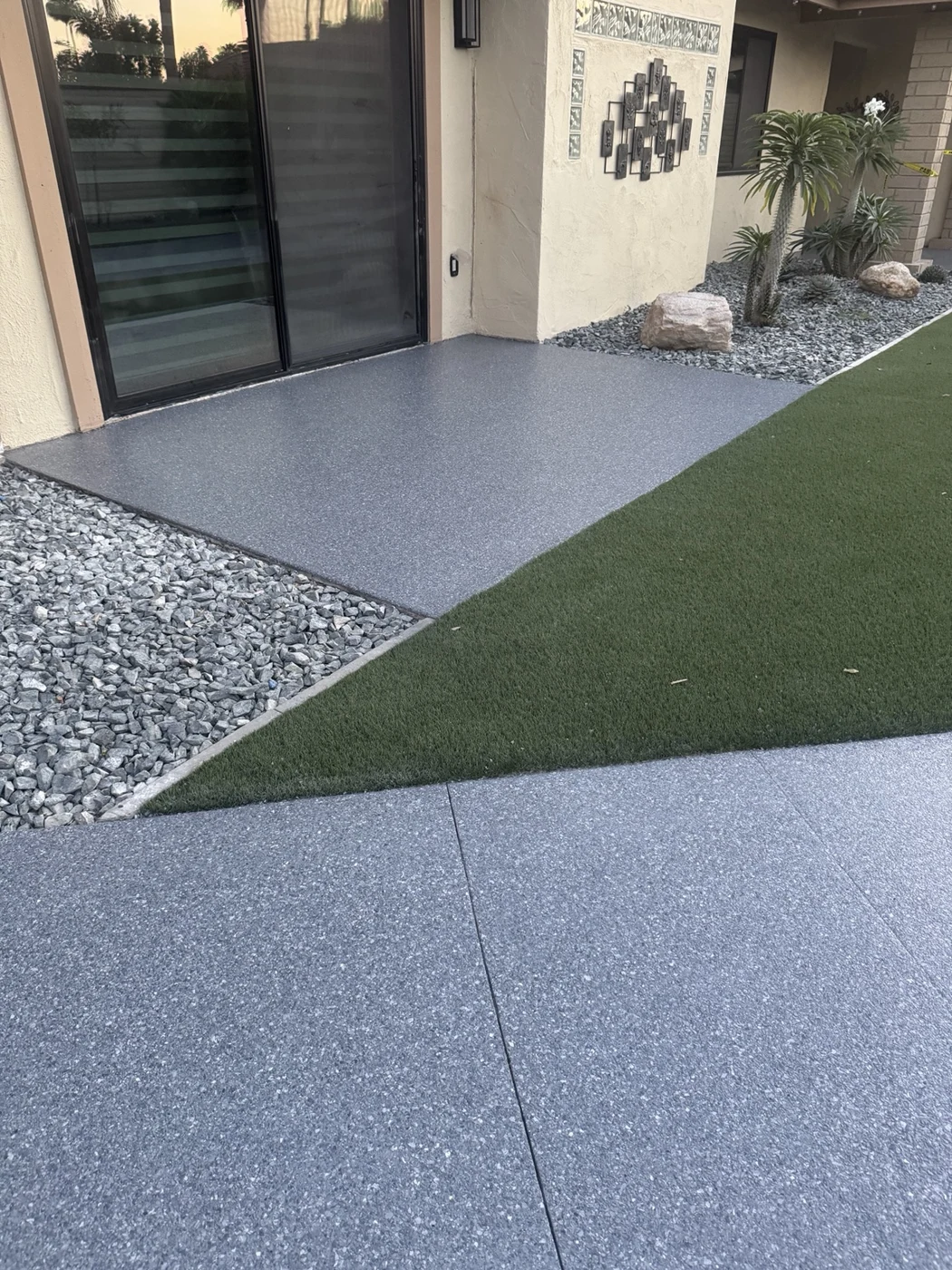 Acre outdoor flake coating on a patio beside a sliding door